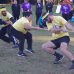 JMCOlympics yellow team playing tug a war.