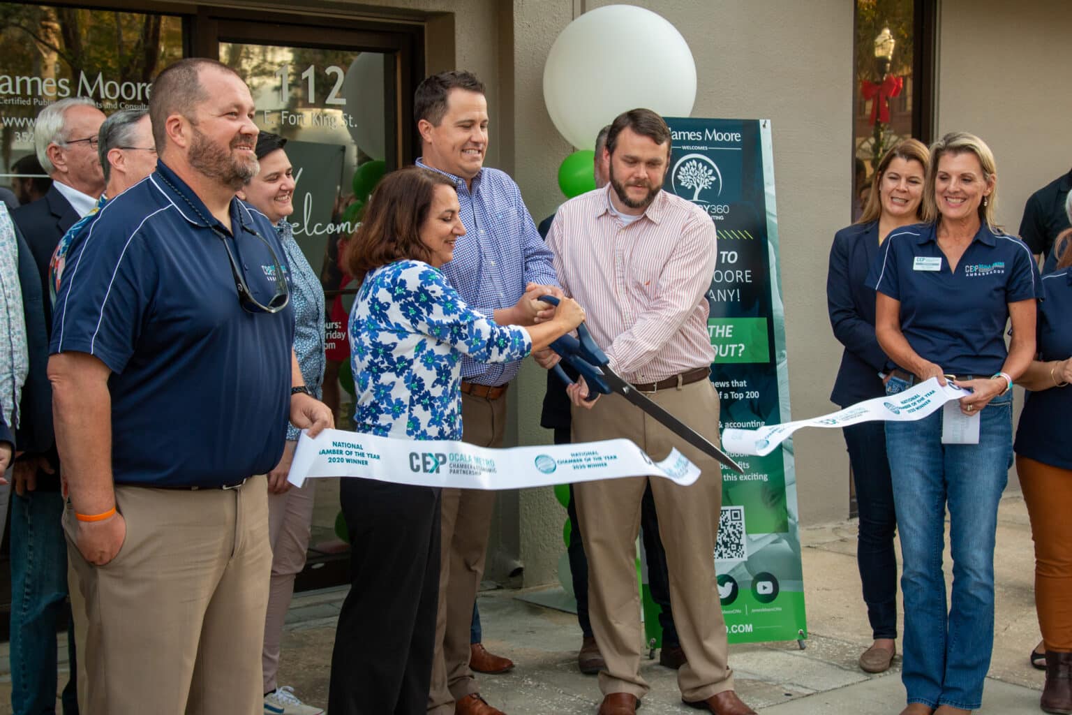 Ribbon cutting ceremony at the new James Moore Ocala office location, merging with CANOPY 360.