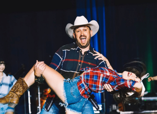 Karsten smiling and dipping his dance partner.