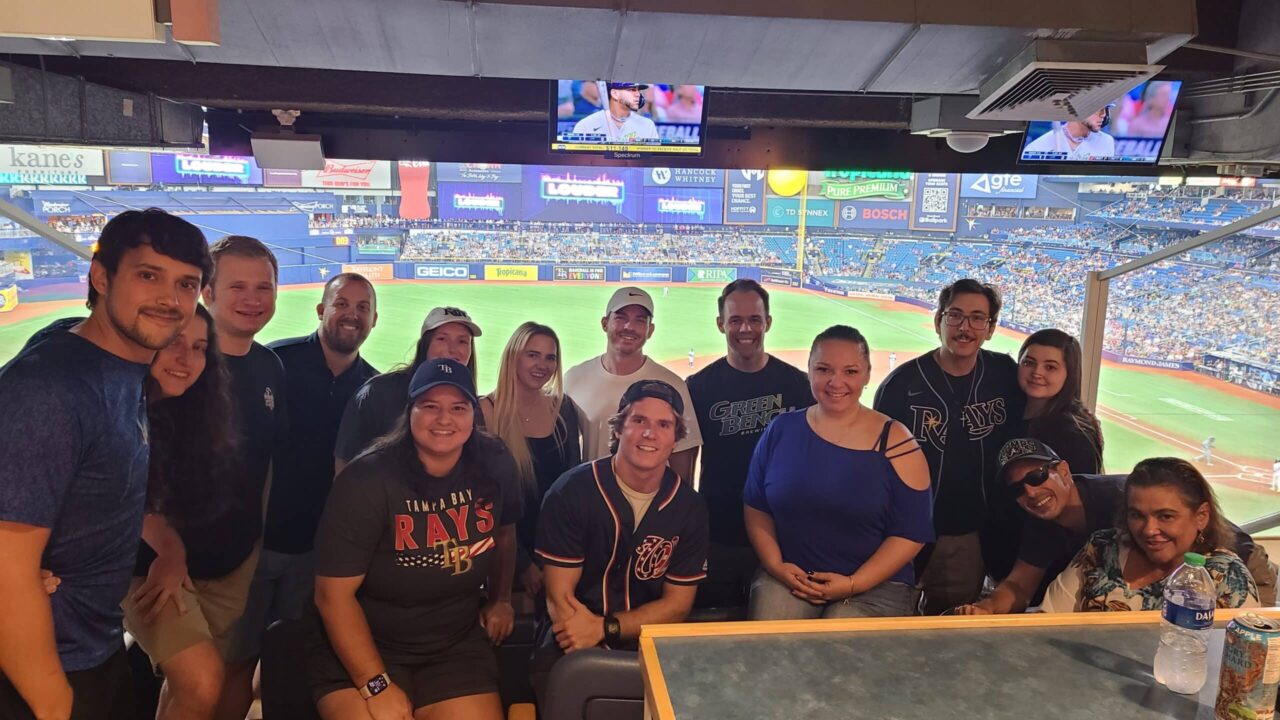 A picture of members of the James Moore government segment team attending a Tampa Rays baseball game.